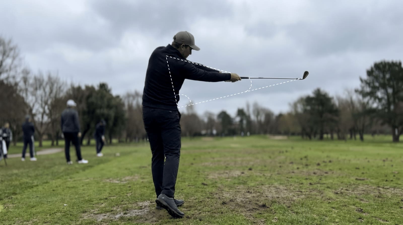 Down-the-line view of a golfer midway into the downswing with the club shaft already lined up with the lead arm, the signature look of casting and lost lag.